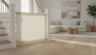 Neutral fabric safety gate fitted across a bright modern stairway