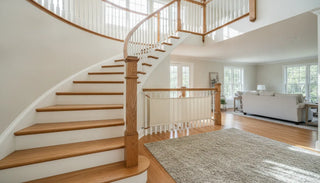 Neutral fabric baby gate on an elegant open staircase