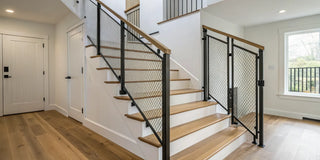 A retractable baby gate installed at the top of a modern staircase.