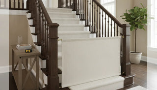 Fabric safety gate installed between wooden stair banisters