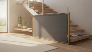 A modern fabric safety gate installed at the bottom of stairs in a beautifully designed home