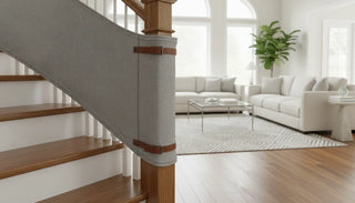 A premium fabric safety gate installed across a staircase with round wooden banisters, wrapping the curved post cleanly without drilling.