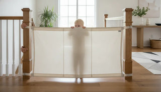 Neutral fabric child proof banister to banister gate across a wide stair opening