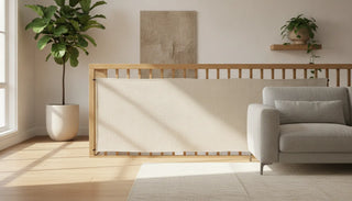 Elegant fabric safety gate across a modern oak banister in a designer living room
