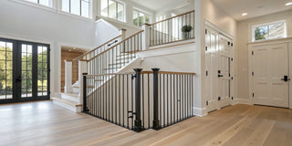 A secure stair safety gate installed at the bottom of a staircase in a modern home.