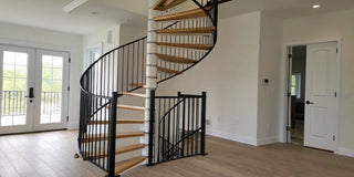Spiral staircase with a safety gate installed at the bottom.