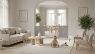 Bright modern open-concept living room with a fabric safety gate at a wide opening, a baby playing safely nearby on a rug