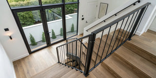 A stylish pocket gate for stairs providing safety on a modern wooden staircase.
