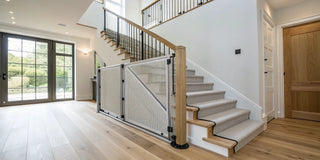 Best retractable stair gate installed on stairs with a wooden banister.