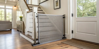 A retractable baby gate installed at the bottom of a staircase.