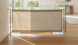 Modern fabric safety gate on a wooden staircase in a contemporary home